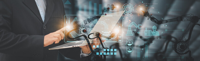 Wall Mural - industry engineer in factory,using laptop computer device,control automated robot arm machine learni