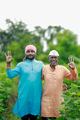 happy two Indian farmer standing in farm