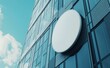 © Zaleman - A mockup of a blank white outdoor round box on a glass building