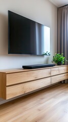 Wall Mural - A sleek black soundbar enhances a tranquil living space with wooden cabinets and lush green plants