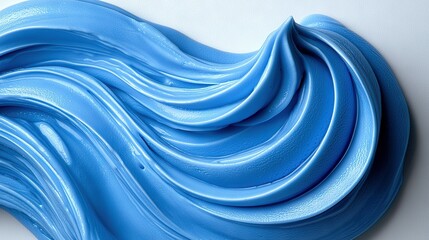 Wall Mural -   Close-up of a blue-iced cake on a white surface with a blue swirl in the center