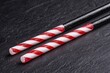 © Balaraw - Striped candy canes on dark background