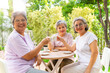 © CandyRetriever  - Group of Happy Asian senior mature women relax and enjoy indoor lifestyle meeting party together at home. Elderly retired woman friends drinking tea with talking together in the garden in summer day.