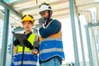 © CandyRetriever  - Professional Asian man and woman teamwork engineer in safety uniform working at outdoor construction site rooftop. Industrial technician worker maintenance checking building exterior plumbing systems.