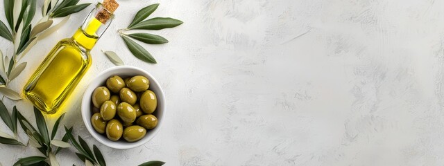  A bowl of green olives, a bottle of olive oil, and an olive branch