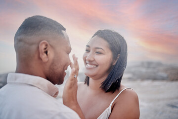 Happy, marriage and couple on beach at sunset on romantic date for travel with vacation or weekend trip. Smile, bonding and young man and woman with connection by ocean in evening on tropical holiday