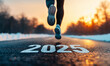 © Patrick - Runner's feet on road with 2025 text at sunset, new year goals and fitness resolutions concept
