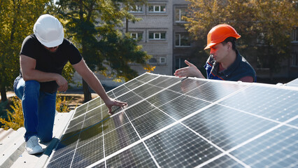 Wall Mural - Professional engineers inspect solar panel installation on a rooftop under sunlight. Detailed check of the solar system setup for efficiency and quality.