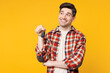 © ViDi Studio - Young smiling happy man wear red checkered shirt casual clothes hold car key fob keyless system look aside on area mockup isolated on plain yellow orange background studio portrait. Lifestyle concept