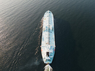 A large gas tanker vessel sails in the Baltic Sea, drone view.