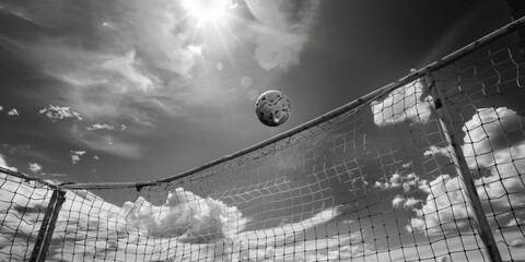 Wall Mural - A black and white image of a soccer ball mid-air, perfect for sport-themed projects or creative compositions