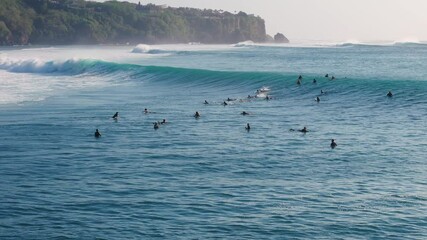 Canvas Print - Perfect waves with surfers at Bali on Padang Padang beach. Drone view of surfing on ocean wave. 