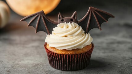 Bat-shaped cupcake with wings spread wide, flying over a full moon, Halloween cupcake, bat-themed spooky treat