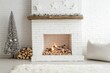 © KumCup - Minimalistic winter-themed fireplace with a white brick mantel, decorated tree, and firewood.