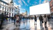 © Julia - Blank advertising billboard mockup in a busy madrid city square with blurred pedestrians and historical architecture