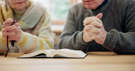 Wall Mural - Hands, senior couple and bible for praying, faith and worship Jesus Christ, holy spirit and God at home. Closeup, rosary and reading gospel books for christian prayer, gratitude or spiritual religion