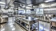 © Four888 - Sparkling stainless steel countertops, shiny equipment, and spotless floors showcase a meticulous cleaning job in a modern commercial kitchen.