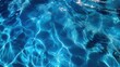 © MakoPoko - Clear blue pool water with ripples, creating a calming and refreshing scene.