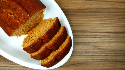 Isolated cinnamon cake and slices on the wooden table with copy space
