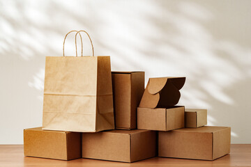 Brown Paper Bag and Cardboard Boxes on a Wooden Surface