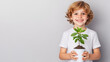 © Chuemon - a happy child with a big smile holds a potted tree with both hands. isolated on white background
