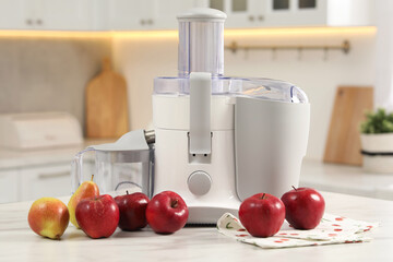 Canvas Print - Modern juicer, pears and apples on white marble table in kitchen