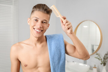 Canvas Print - Handsome man with comb and towel in bathroom