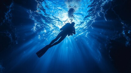 Wall Mural - A diver glides through tranquil turquoise waters, illuminated by beams of light penetrating the surface, exploring the depths of the ocean in peaceful solitude