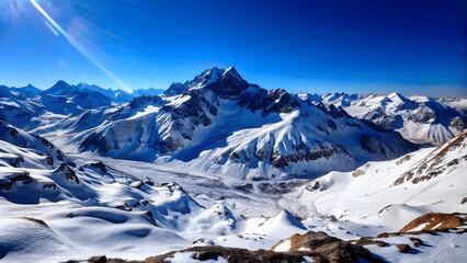 Sticker - A panoramic view of a snowy mountain range under a clear blue sky