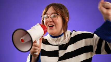 Surprised shocked excited fun young woman 20s yell into megaphone announcing discounts, sale, hurry, isolated on purple background 