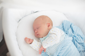 Wall Mural - Little baby on white bed