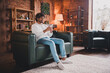© deagreez - Photo of funky cool guy dressed white pullover communicating modern gadget indoors house apartment room