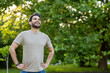 © Tetiana - Joyful man enjoying outdoor fitness in lush park setting wearing casual clothing and smiling brightly