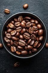 Wall Mural - Freshly roasted coffee beans in a black bowl on a textured dark surface