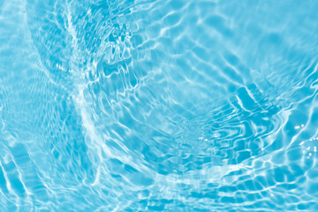 Sticker - Blue water with ripples on the surface. Defocus blurred transparent blue colored clear calm water surface texture with splashes and bubbles. Water waves with shining pattern texture background.