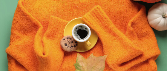 Wall Mural - Composition with warm sweater, cup of coffee and pumpkins on color background