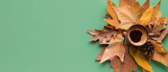 Wall Mural - Composition with cup of aromatic coffee, fallen leaves and cone on green background