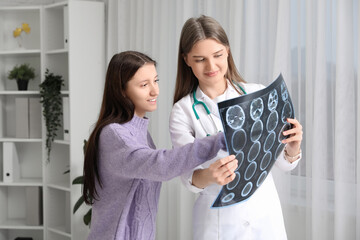 Sticker - Beautiful doctor showing x-ray scan to patient in clinic