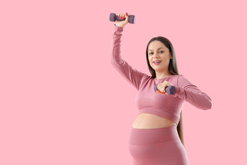 Poster - Sporty pregnant woman with dumbbells on pink background