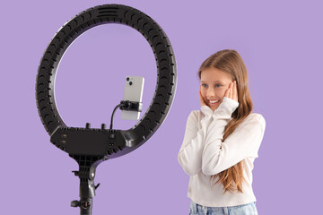 Canvas Print - Teenage blogger recording video on lilac background