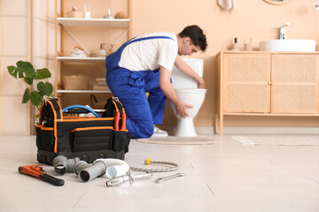 Poster - Tool bag with pipes and plumber tools in bathroom, closeup