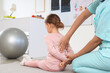 © Pixel-Shot - Female osteopath with little patient stretching and doing exercises in clinic