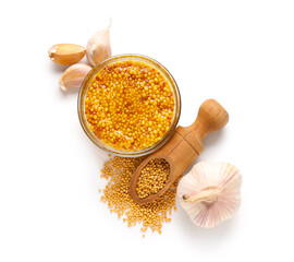 Poster - Glass bowl of Dijon mustard with garlic and seeds on white background