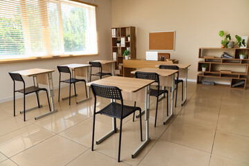 Wall Mural - Interior of empty classroom with desks and chairs at school