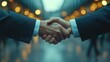 © Attasit - A business deal being closed with a handshake, signifying the successful negotiation between two corporate entities.