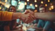 © Attasit - A team celebrating a successful collaboration, with handshakes and smiles indicating a job well done.