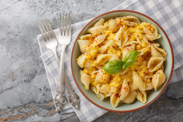 Sticker - Creamy corn pasta with fresh basil is a bright meatless meal that's fast, simple, and makes the best effortless summer dinner closeup in the bowl on the table. Horizontal top view from above