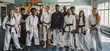 © Mahemud - Coaches and students posing in a martial arts studio.