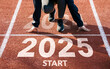 © Deemerwha studio - New year resolution 2025 concept. Word start 2025 written on athletics track and athlete woman runner preparing for new year for challenge and change. planning health and the goal to success