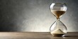© PloyJai - Hourglass countdown showing sand passing in empty grey background space